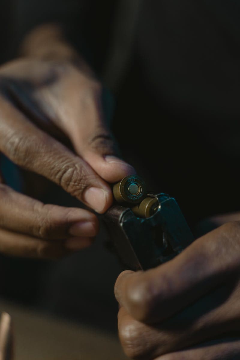 Hands loading a firearm magazine during training